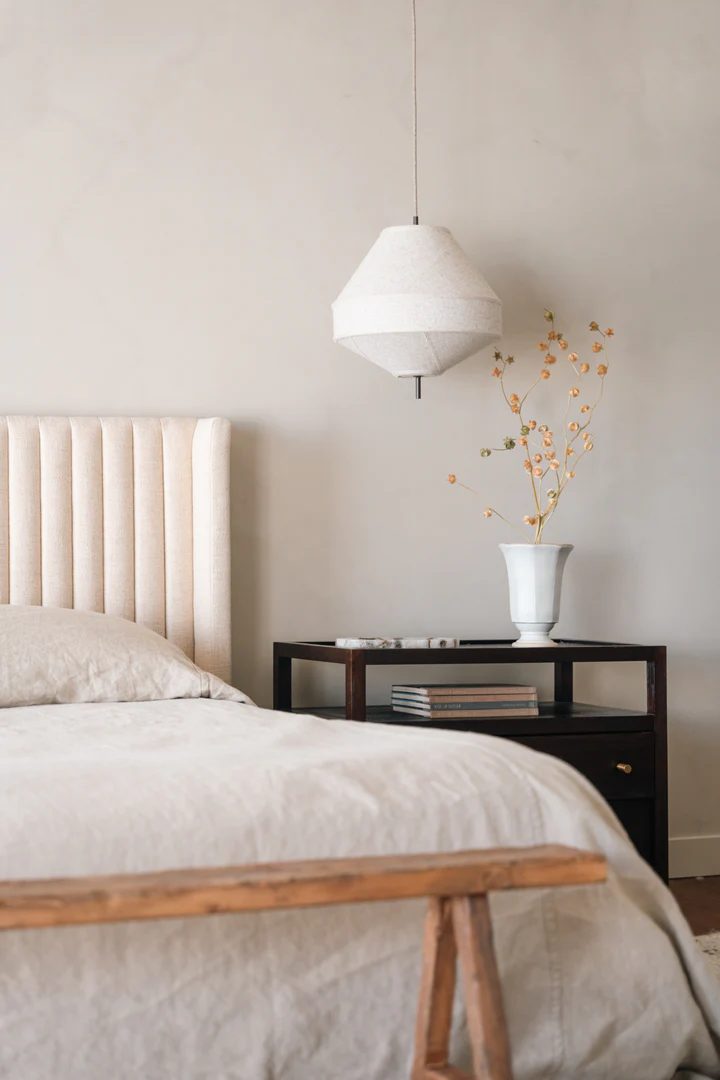 American clay plaster bedroom wall in a pale neutral tone