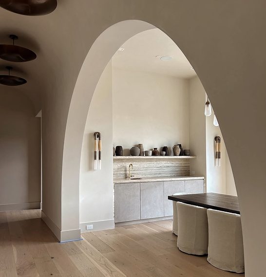 Arched plaster kitchen opening in a warm neutral finish