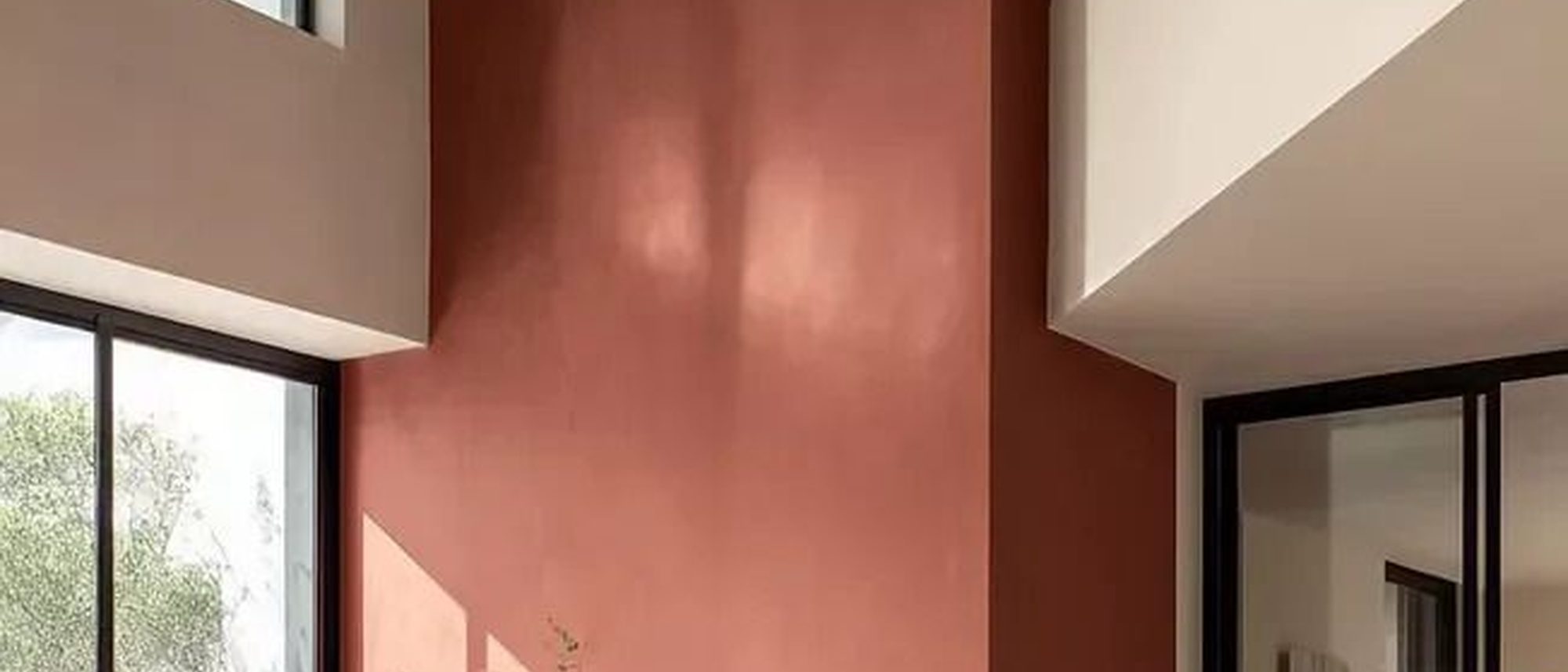 Moroccan clay plaster wall with deep, saturated pigment and a soft sheen