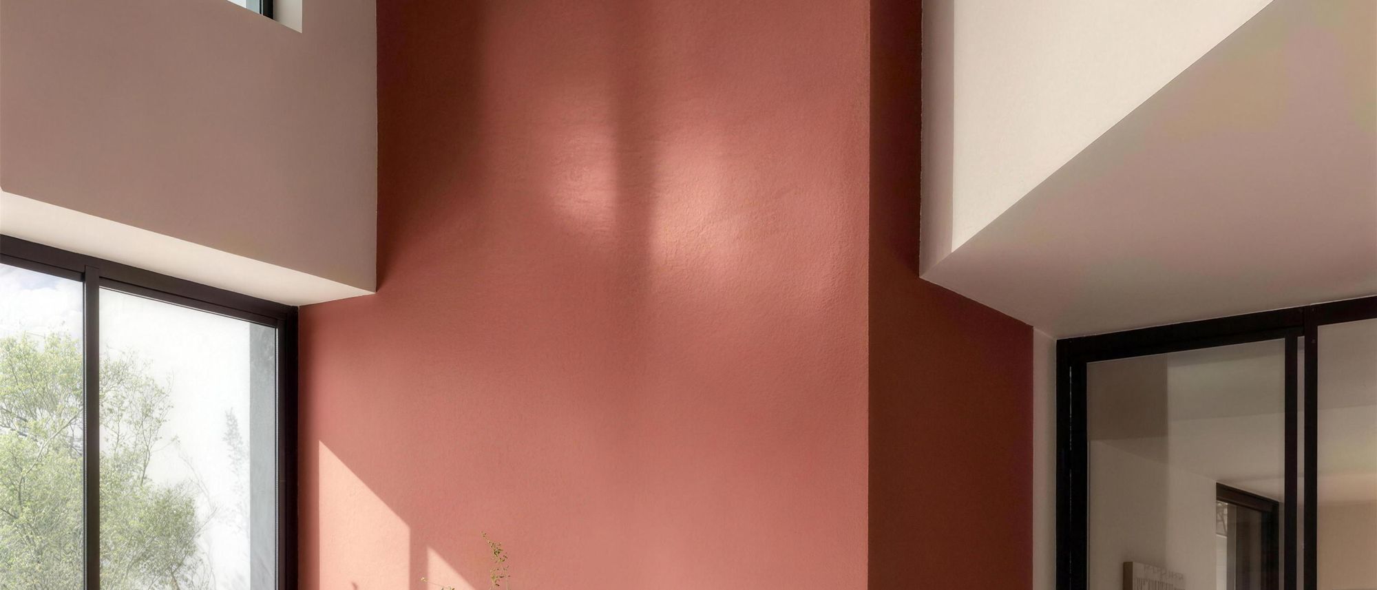 Moroccan clay plaster wall with deep, saturated pigment and a soft sheen