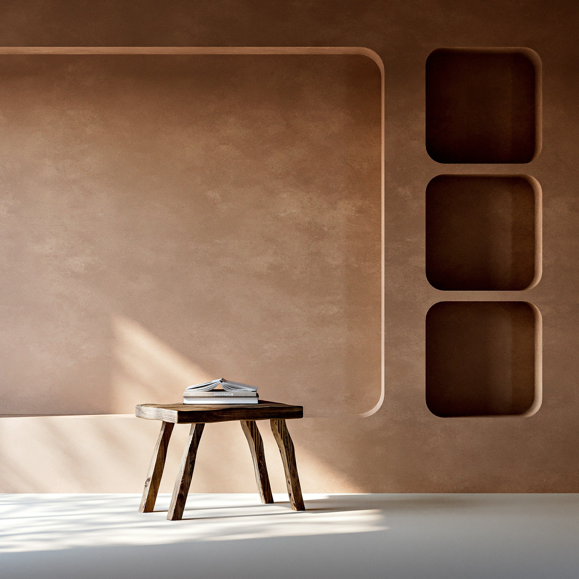 Earth-toned clay plaster walls with a built-in niche and a wooden stool