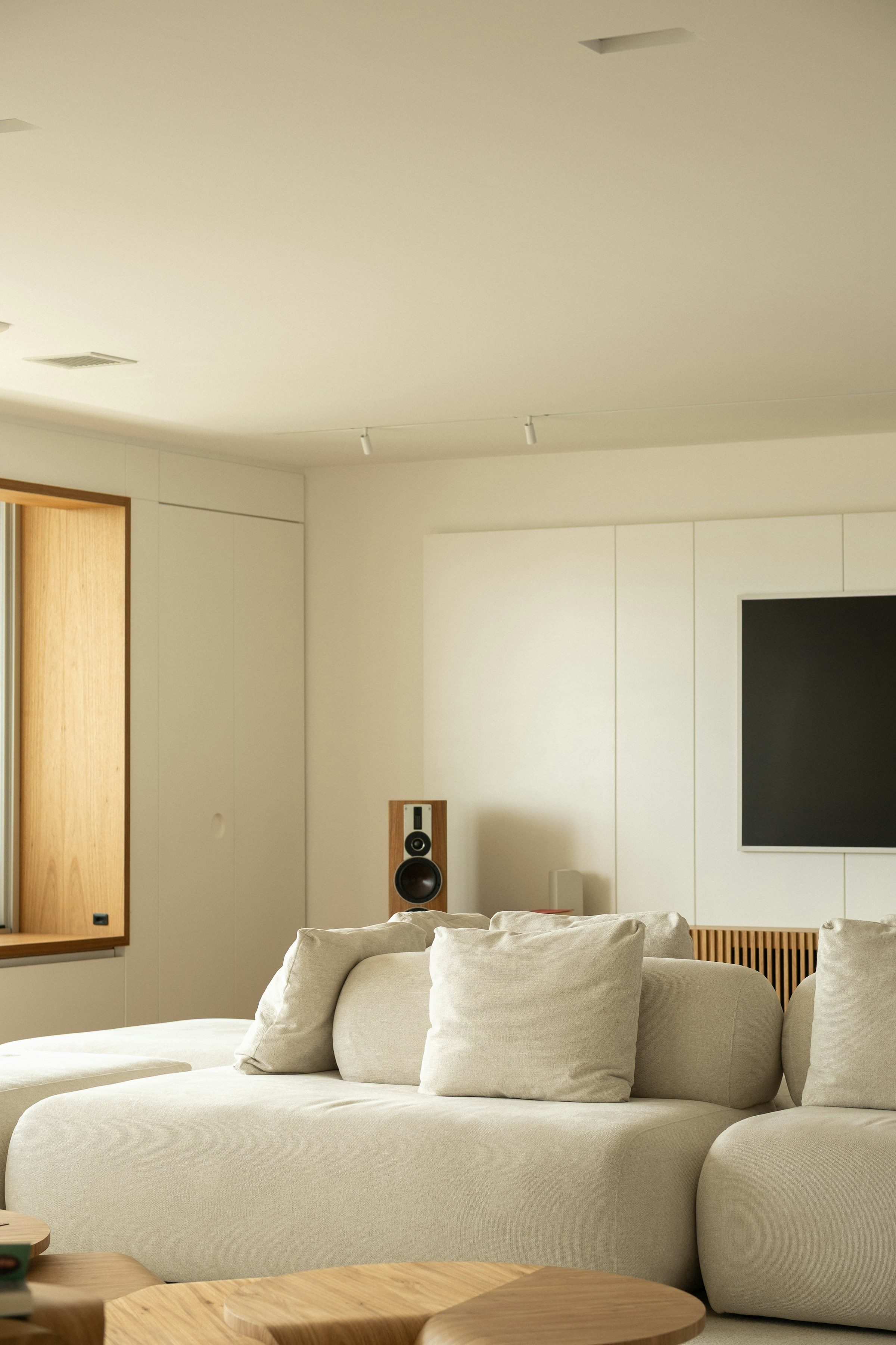 Understated cream plaster walls in a calm living room