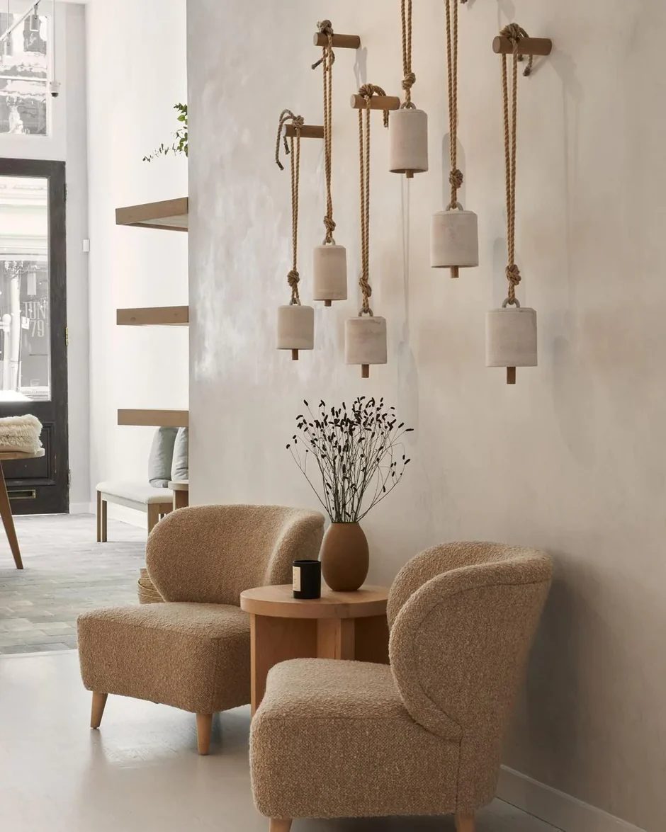 Warm plaster interior with soft seating and sculptural pendant lighting